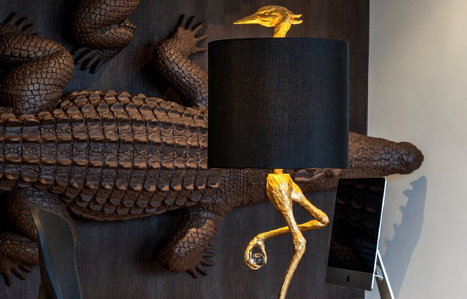 Golden bird lamp and crocodile wall art